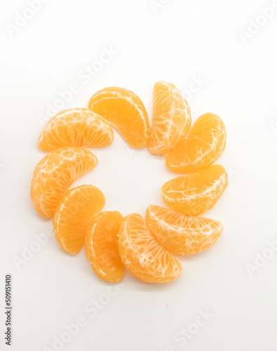 some slices of tangerine or komola isolated on white background,