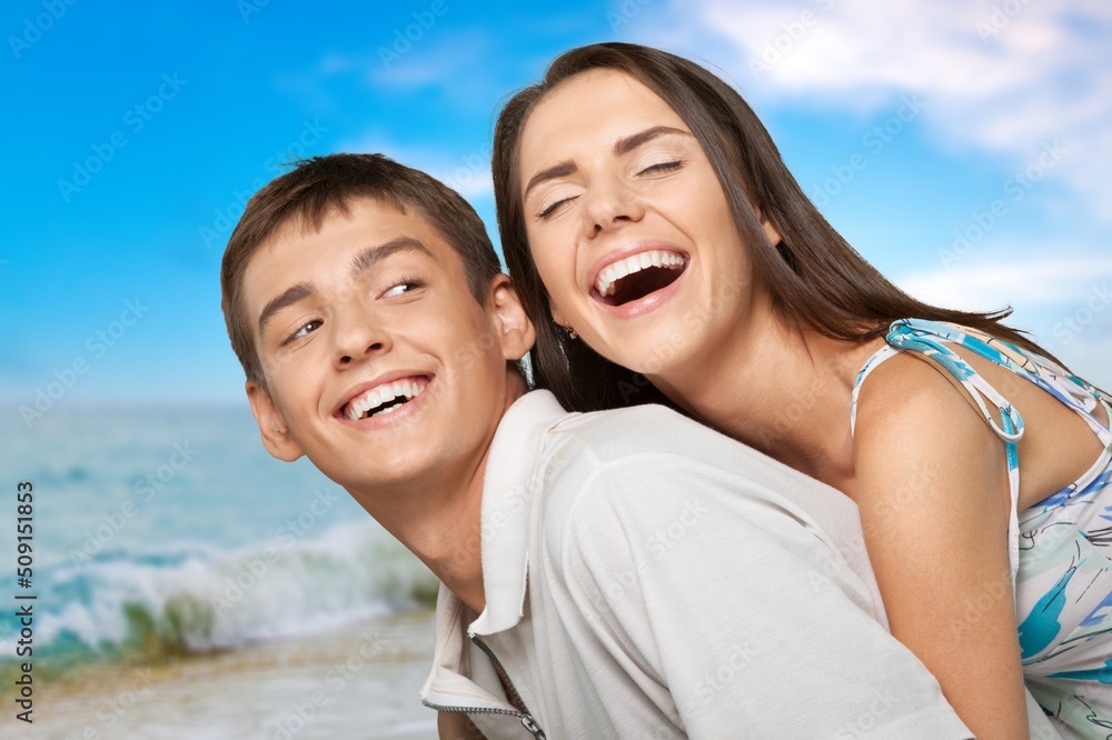 Young cheerful happy couple to joyful, over sea beach ocean outdoor seaside in summer day Young cheerful happy couple to joyful, over sea beach ocean outdoor seaside in summer day