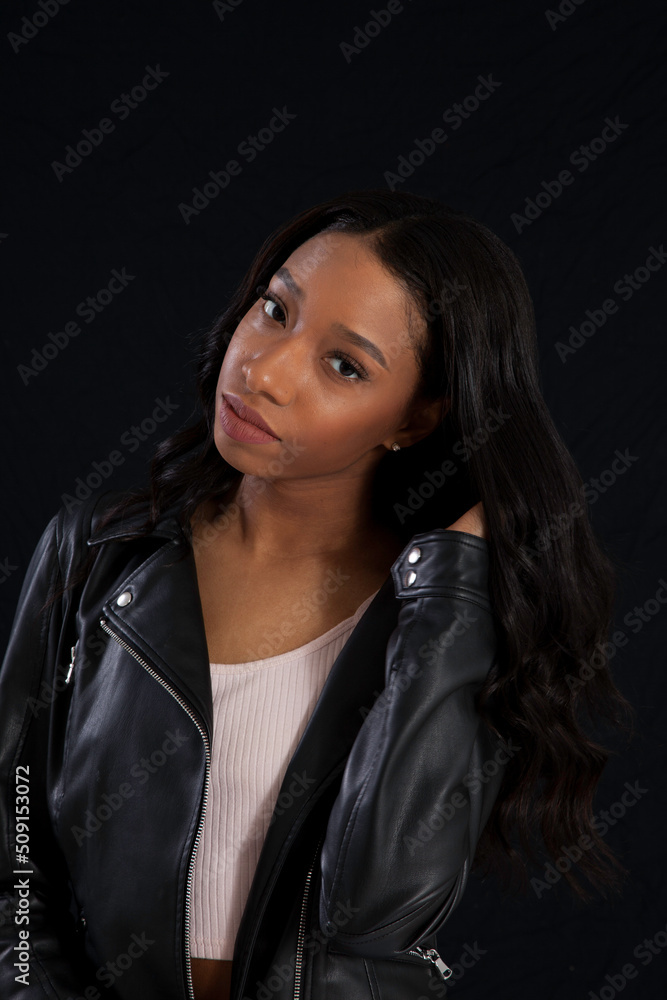 Beautiful woman in a black leather jacket, looking pensive