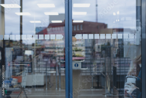 Photography Closed glass supermarket automatic door, front view.