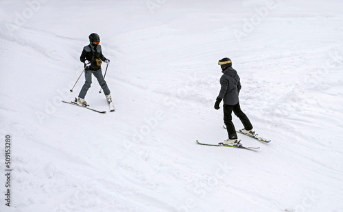 unknown unrecognizable skier learns Snowplough skiing technique