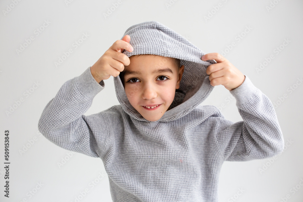 Boy child preschooler smiling and posing on gray background in photo studio Boy child preschooler smiling and posing on gray background in photo studio