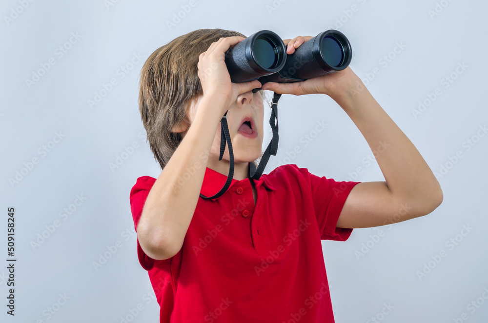 Kid posing with binoculars and surprised Kid posing with binoculars and surprised