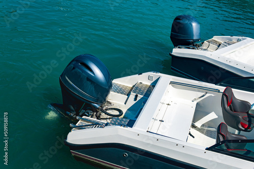 Fototapeta two moored motorboats with outboard motors