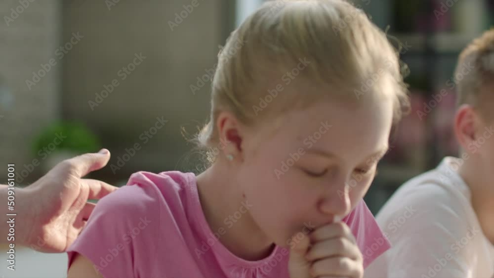 Girl laughing and choking on food at breakfast Girl laughing and choking on food at breakfast
