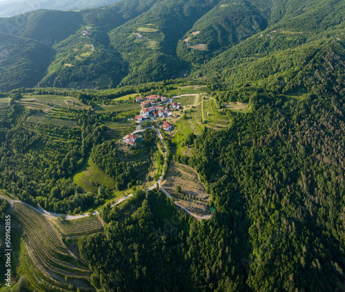 Landscape in Goriska Brda, from above with small village, vineyards, olive plantations in the middle of the forest, Slovenia
