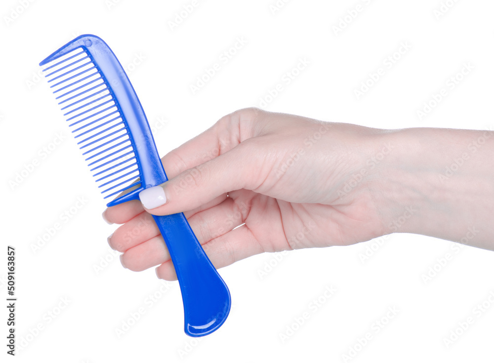 Blue hair comb in hand on white background isolation Blue hair comb in hand on white background isolation
