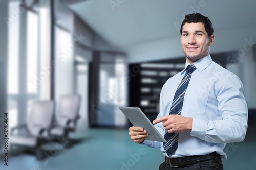 Happy successful business man posing on background