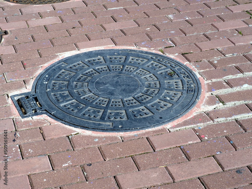 Sewer manholes on the cobblestone pavement Sewer manholes on the cobblestone pavement
