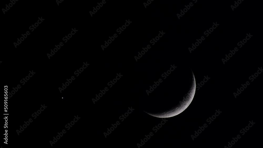 Scene of a waxing crescent moon shining alongside a single bright star against a dark black sky, enhanced by a subtle heat haze effect. Composition copy space,  ideal for various creative uses.