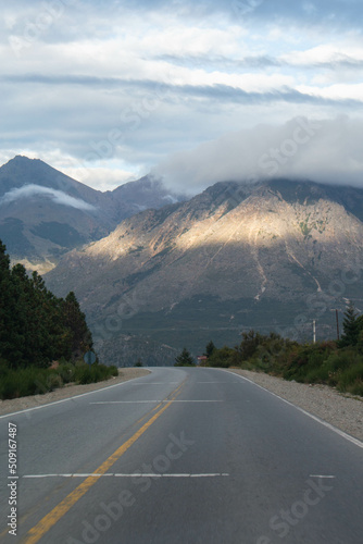 highway with background of mountains and sunbeams through the clouds, Patagonia Argentina © Alberto