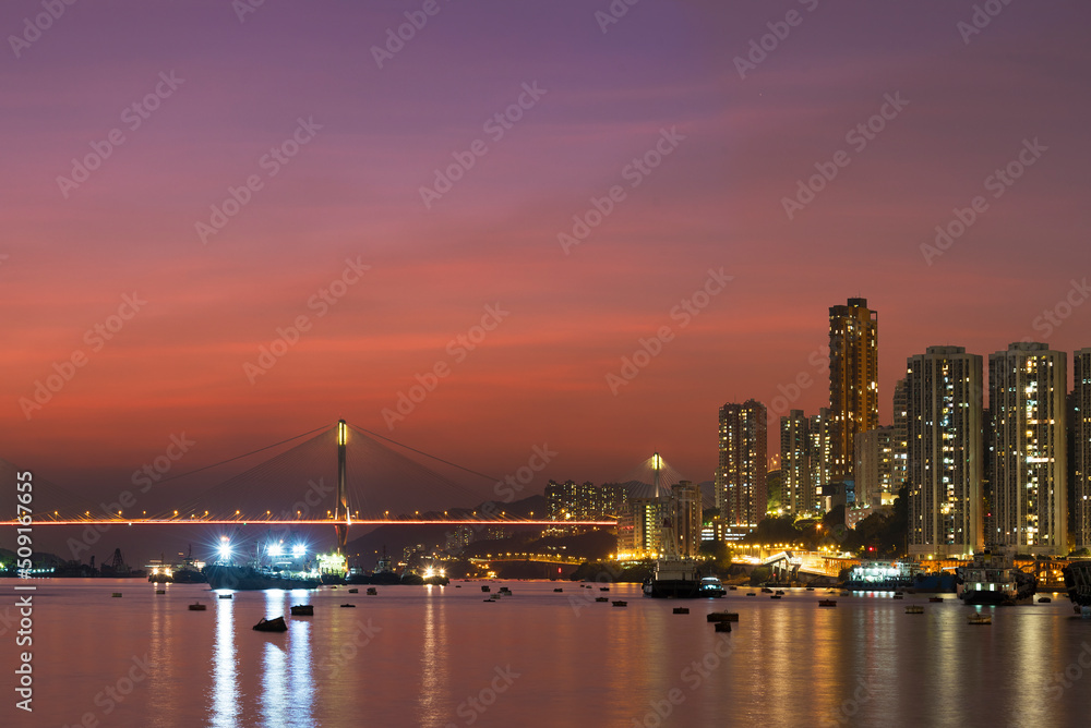 Idyllic landscape of harbor and skyline of Hong Kong city at dusk