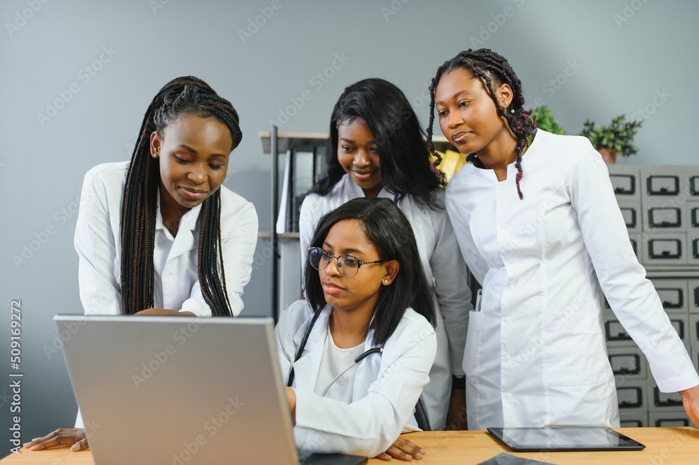 Group Of Medical Staff Meeting Around Table In Hospital. Group Of Medical Staff Meeting Around Table In Hospital.
