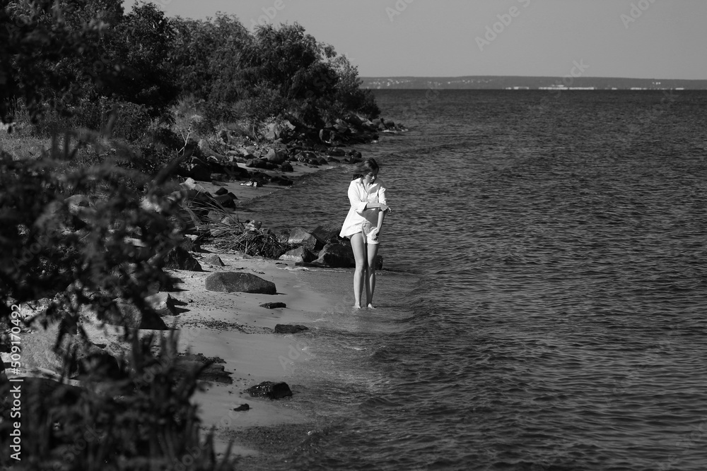 Beautiful woman in shirt playing in the sea in black and white Beautiful woman in shirt playing in the sea in black and white