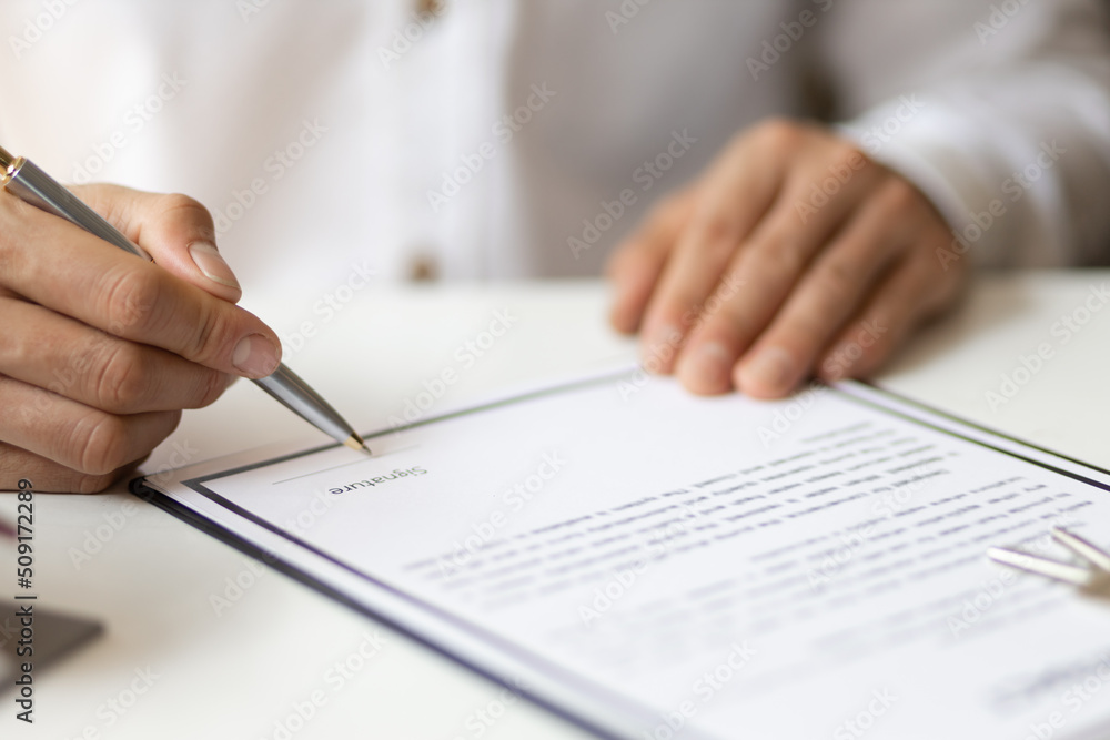 Businessman in casual clothes signing a real estate deal contract. Businessman in casual clothes signing a real estate deal contract.