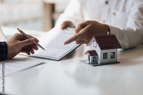 Close up businessman signing a real estate deal contract.