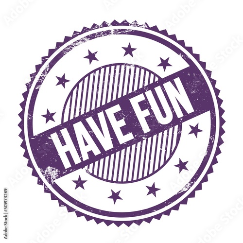 Φωτογραφία HAVE FUN text written on purple indigo grungy round stamp.