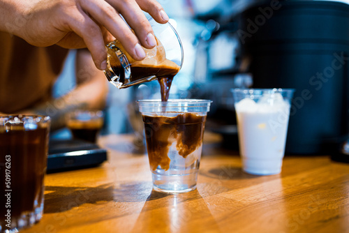 Barista preparing ice americano