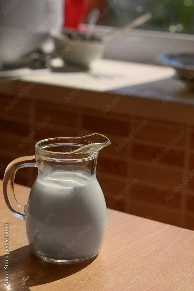 A jug of milk on a rustic table. A jug of milk on a rustic table.