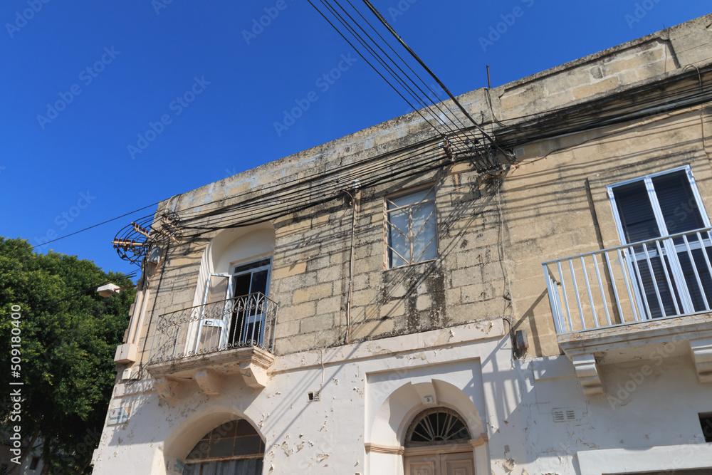 Messy electrical cables on wall corner in Malta