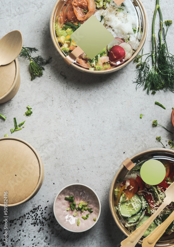 Photography Healthy salads lunch in sustainable packaging with empty label mock up at grey table background with herbs and biodegradable food containers