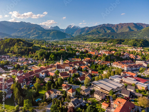 Aerial: Photo of Beautiful Old Town Surrounded By Lush Green Mountain Landscape At Kamnik, Slovenia photo