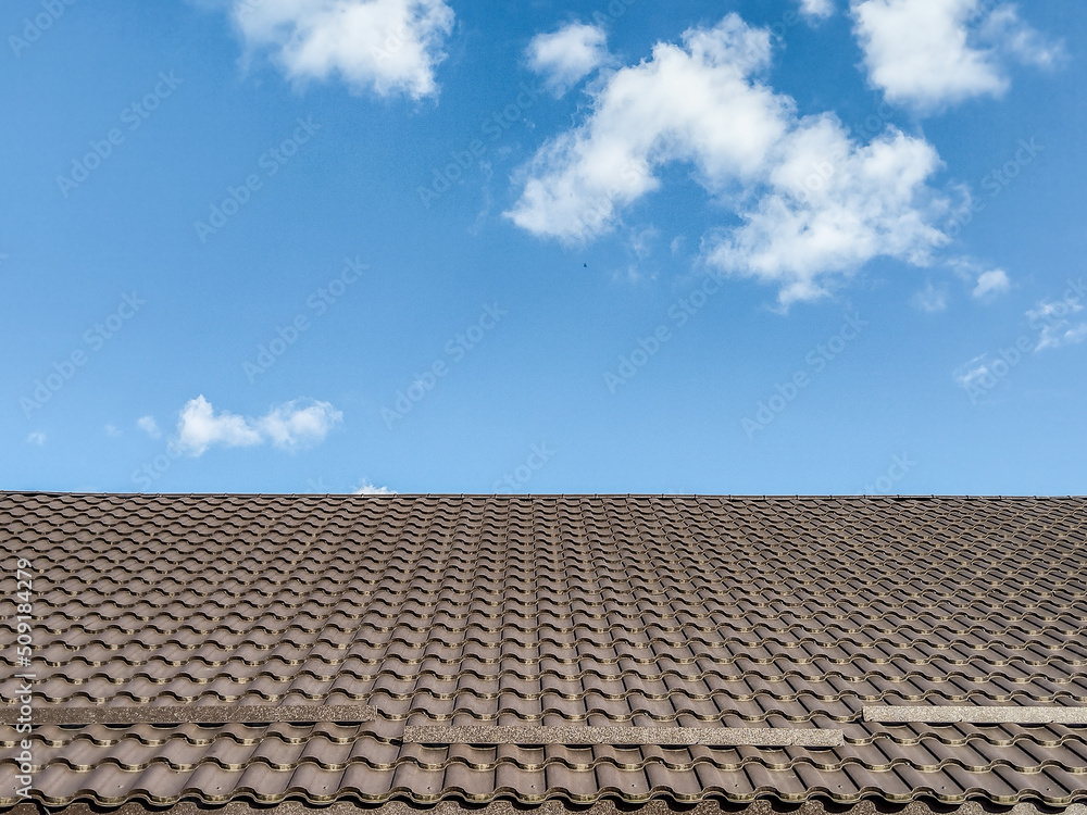 the tiled roof of a house and a clear sky the tiled roof of a house and a clear sky