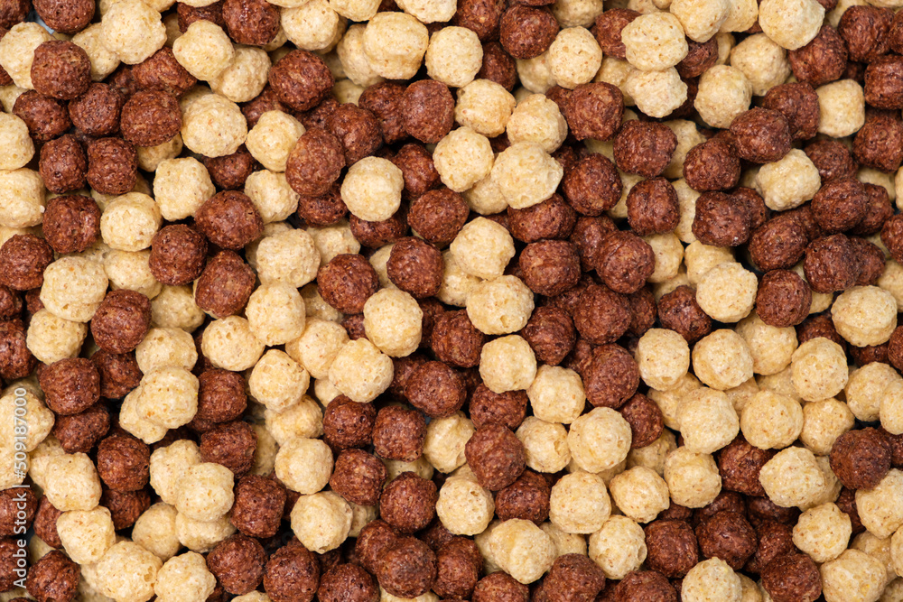 Breakfast cereal - corn and wheat balls with cocoa on a blue background, top view Breakfast cereal - corn and wheat balls with cocoa on a blue background, top view
