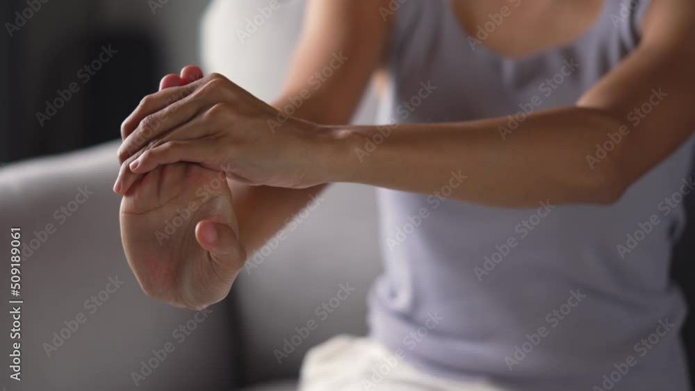 Young Asian woman suffering pain on hands and fingers, arthritis inflammation. Woman has pain in wrist. Health care and medical concept. Young Asian woman suffering pain on hands and fingers, arthritis inflammation. Woman has pain in wrist. Health care and medical concept.