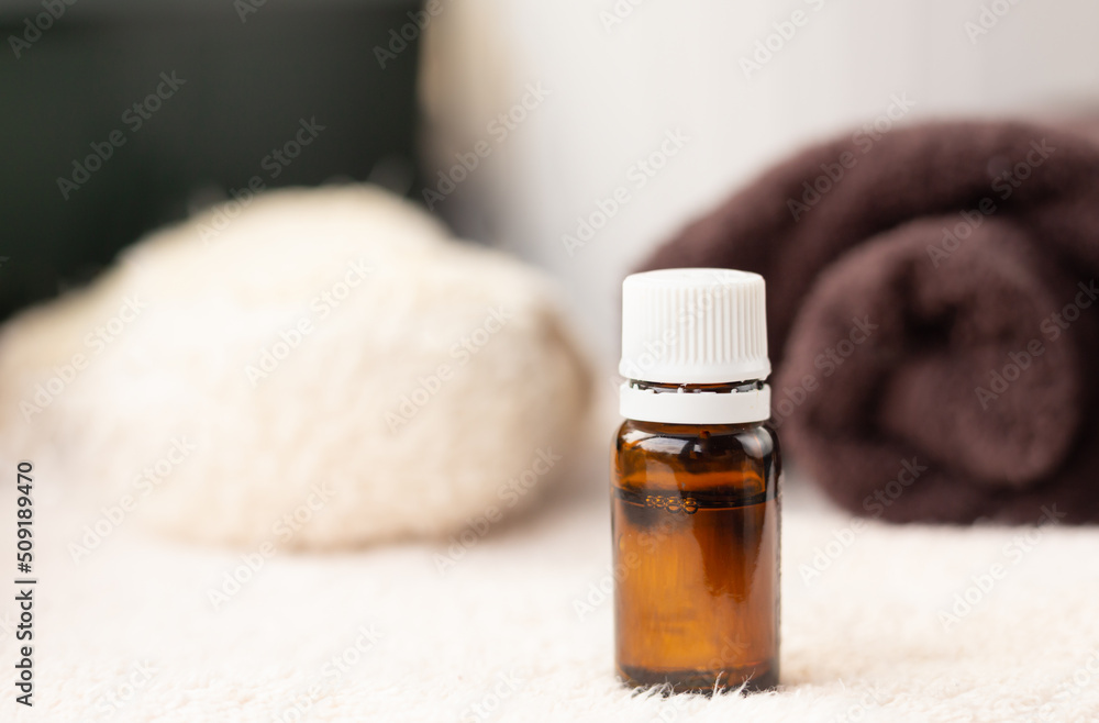 ESSENTIAL OIL in dark bottle , white towel, body brush, copy space, spa procedures products, eco cosmetic ESSENTIAL OIL in dark bottle , white towel, body brush, copy space, spa procedures products, eco cosmetic