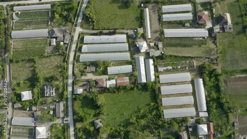 Aerial View Of Greenhouses Structure In Rural Area At Daytime. Aerial View Of Greenhouses Structure In Rural Area At Daytime.