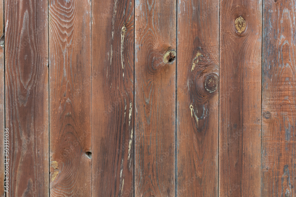 The background is made of brown boards painted with stain. The texture of a wooden table, fence. The background is made of brown boards painted with stain. The texture of a wooden table, fence.