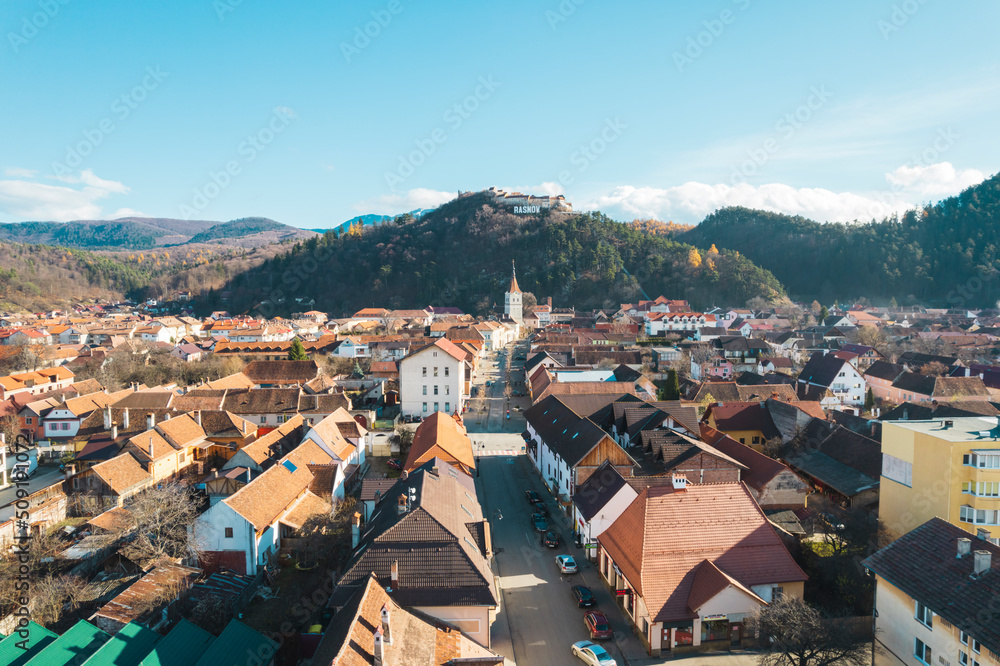Aerial view of Rasnov, Romania shows that the buildings are styled with medieval fortress architecture. Medieval fortification in Brasov