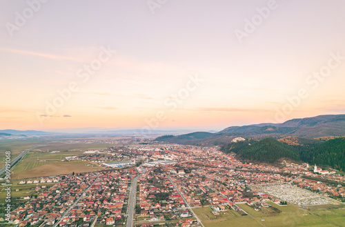 Aerial view of Rasnov, Romania shows that the buildings are styled with medieval fortress architecture. Medieval fortification in Brasov. Drone shot of Rasnov Medieval city