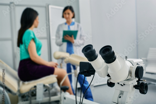Woman patient sitting in gynecological chair during consultation with her gynecologist in medical clinic. Women's health, colposcopy, gynecology photo