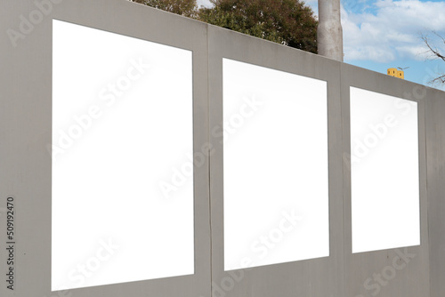 Concrete wall with three blanks for advertisements