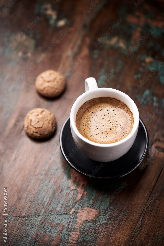 Cup of coffee with Amaretti (Italian biscuits) on rustic wooden background. Copy space. Cup of coffee with Amaretti (Italian biscuits) on rustic wooden background. Copy space.