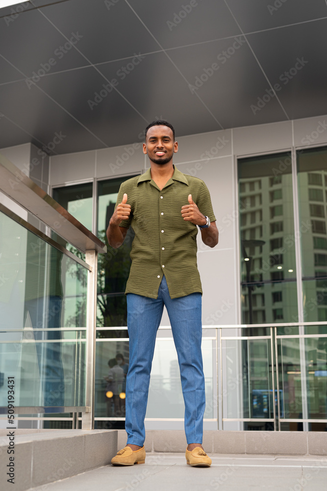 Portrait of handsome young black man outdoors in city