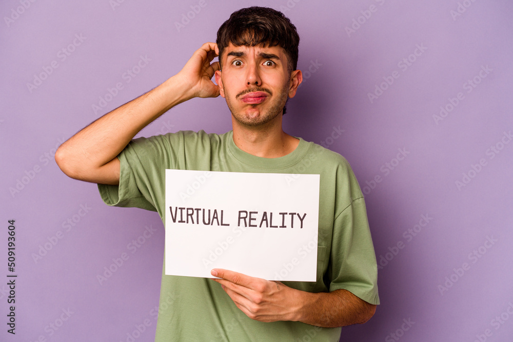 Young hispanic man holding virtual reality placard isolated on purple background being shocked, she has remembered important meeting. Young hispanic man holding virtual reality placard isolated on purple background being shocked, she has remembered important meeting.