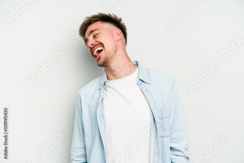 Young caucasian man isolated on white background dancing and having fun.