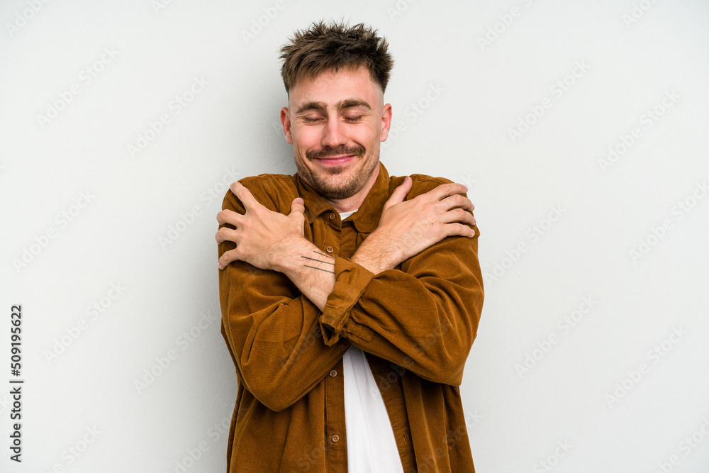 Young caucasian man isolated on white background hugs, smiling carefree and happy. Young caucasian man isolated on white background hugs, smiling carefree and happy.