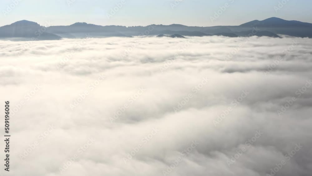 Aerial flight beyond sky over morning fluffy clouds high in the mountains Aerial flight beyond sky over morning fluffy clouds high in the mountains