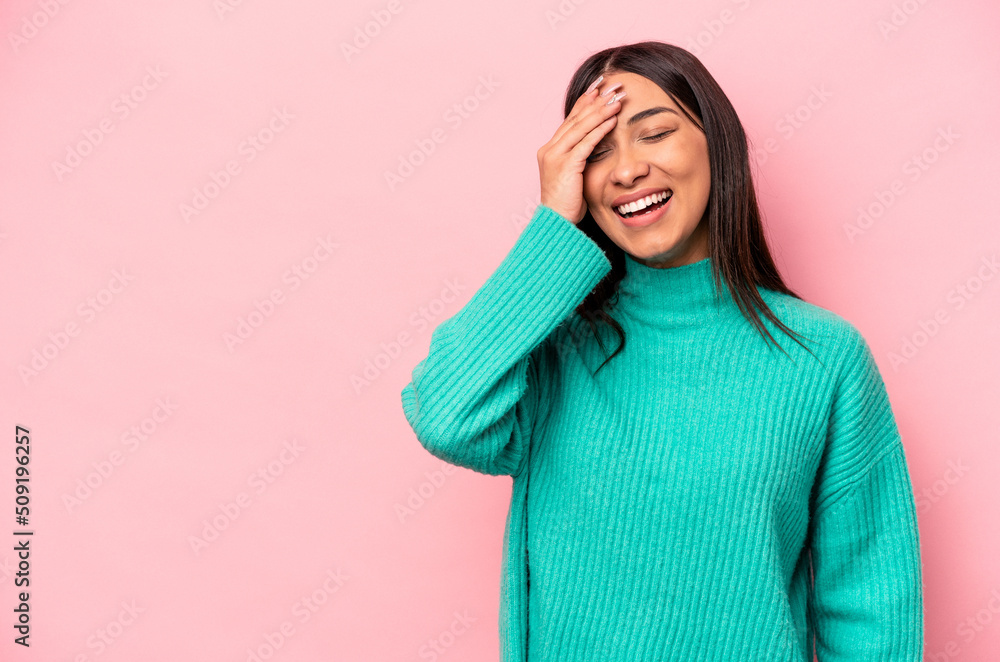 Young hispanic woman isolated on pink background laughing happy, carefree, natural emotion. Young hispanic woman isolated on pink background laughing happy, carefree, natural emotion.