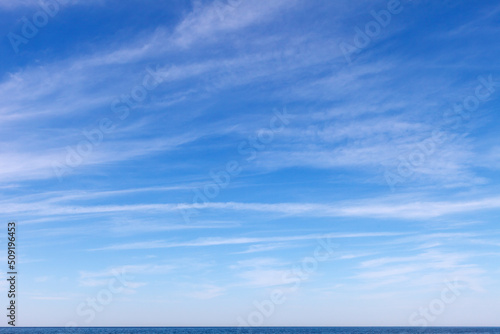 Beautiful blue sky with cirrus clouds over the sea. Skyline.