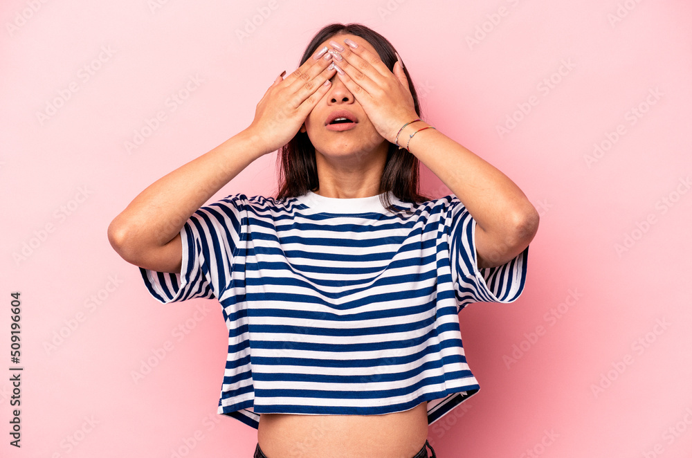 Young hispanic woman isolated on pink background afraid covering eyes with hands. Young hispanic woman isolated on pink background afraid covering eyes with hands.