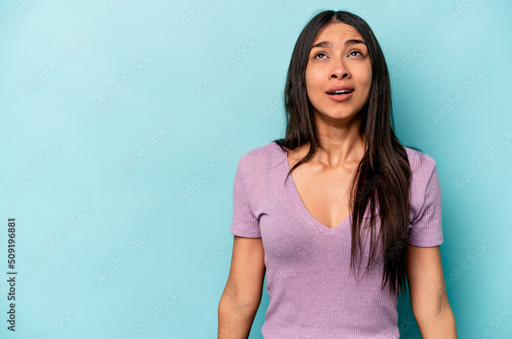 Young hispanic woman isolated on blue background shouting very angry, rage concept, frustrated. Young hispanic woman isolated on blue background shouting very angry, rage concept, frustrated.