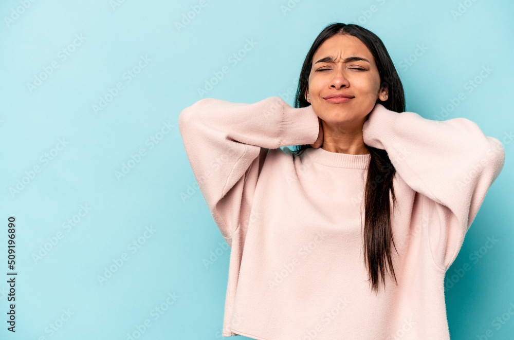 Young hispanic woman isolated on blue background touching back of head, thinking and making a choice. Young hispanic woman isolated on blue background touching back of head, thinking and making a choice.