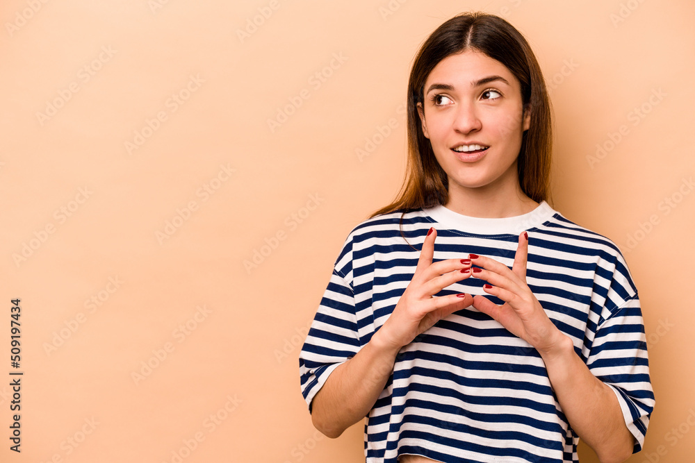 Young hispanic woman isolated on beige background making up plan in mind, setting up an idea. Young hispanic woman isolated on beige background making up plan in mind, setting up an idea.