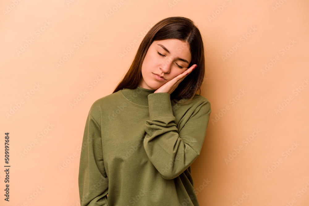 Young hispanic woman isolated on beige background who is bored, fatigued and need a relax day. Young hispanic woman isolated on beige background who is bored, fatigued and need a relax day.