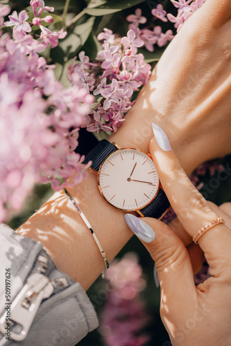 Classic beautiful white watch on woman hand. Close-up photo.